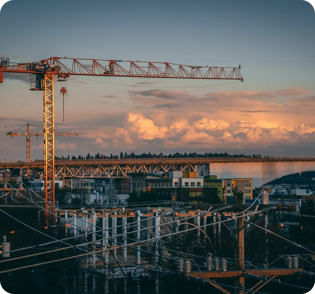 Construction cranes at sunset for a refreshed builder brand