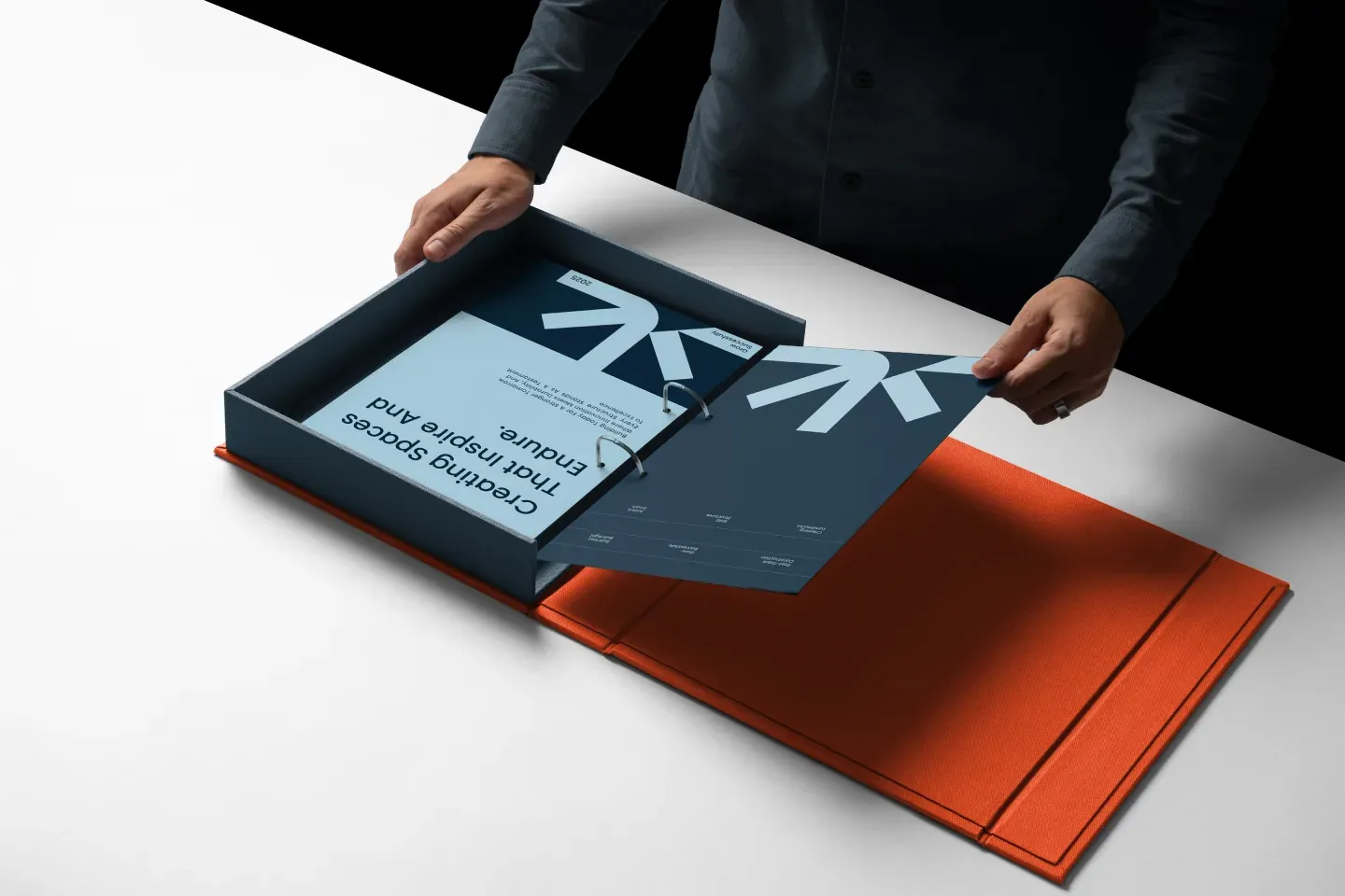 Printed Astrix Builders identity presentation using the logo, typography and color system created by Wolfpixel.
