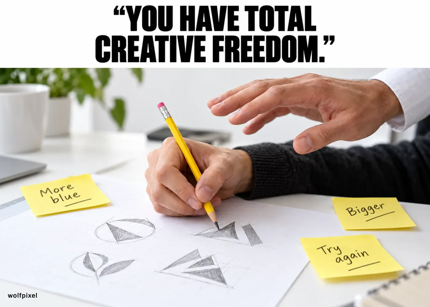 Total creative freedom client meme with a client’s hand hovering over a designer’s pencil sketches